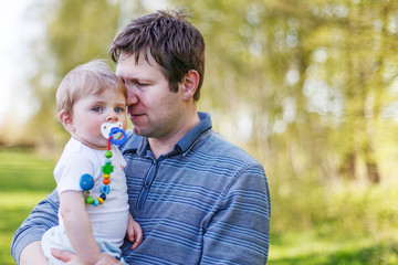 Happy caucasian family of two: Young father andbaby boy in sprin