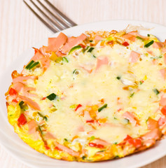eggs with vegetables, ham and cheese