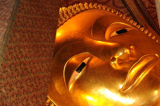 Face Of Golden Reclining Buddha Statue. Wat Pho,Thailand