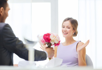 amazed woman recieving bouquet of flowers
