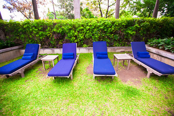 Beach chairs in exotic resort near swimming pool