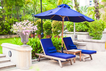 Chaise lounges near pool in luxury resort