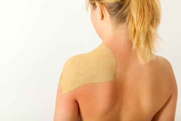 Die junge nackte Frau wird mit Heilerde behandelt