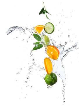 Pieces of oranges and limes in water splash
