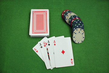 Poker Chips and cards on the baize