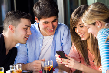 Friends having fun with smartphones