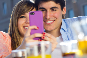 Fototapeta na wymiar Selfie couple taking photos with a smartphone