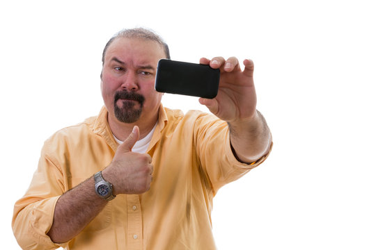 Man taking a selfie while giving a thumbs up