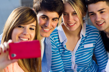 Group of friends taking photos with a smartphone