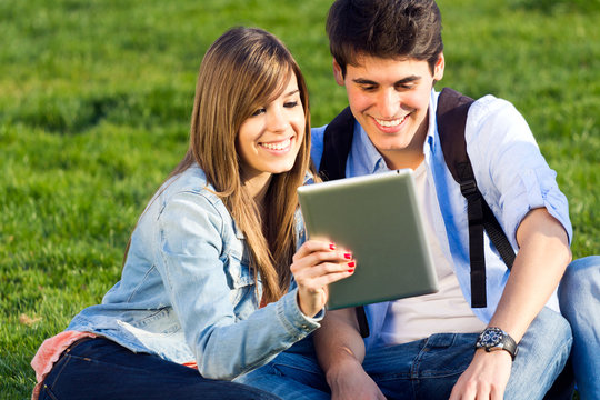 Young couple having fun with digital tablet