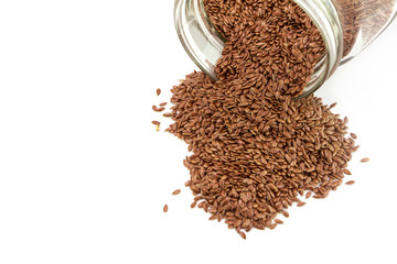 Heap of flaxseed in glass bottle