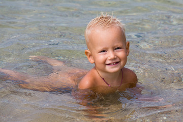 Happy baby at the sea