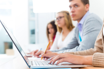 close-up of female hands on the laptop keyboard
