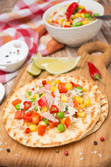 colorful vegetable salad with tuna on wheat tortillas