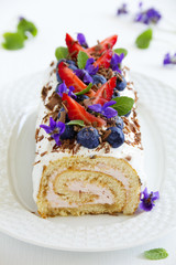 biscuit roll garnished with mint leaves and blueberries