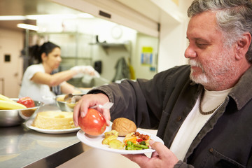 Kitchen Serving Food In Homeless Shelter