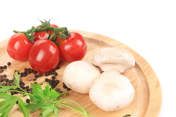 Vegetables on wooden platter.