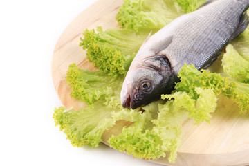 Fresh seabass on platter with lettuce.