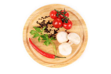 Vegetables on wooden platter.