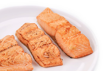 Slices of red fish fillet on plate.