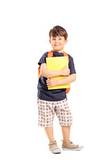 Schoolboy with backpack holding a notebook