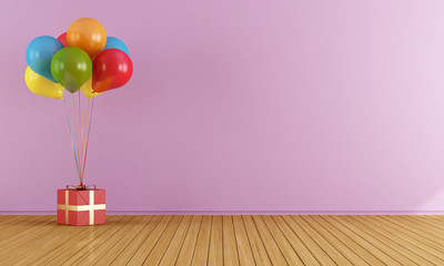 Colorful balloons in a empty pink room © archideaphoto