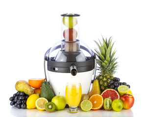 Fresh fruits and glass with juice near withe juicer