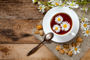 herbal tea with chamomile on old wooden table