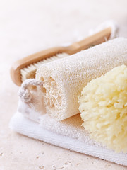Organic Bath Accessories on a Travertine Background