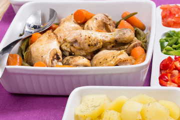 Roasted chicken, peppers, and potatoes in food trys