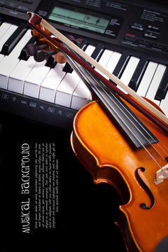 Violin and piano keys on black