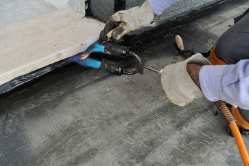 Man applying waterproof coating
