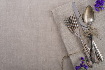 Vintage silverware with flowers and paper rope
