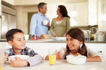 Hispanic Family Eating Breakfast At Home Together