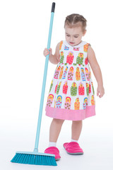Cute little girl sweeps a floor isolated on white