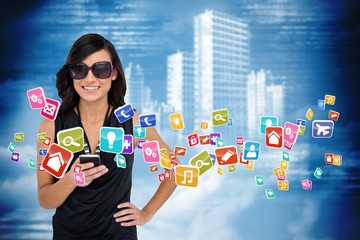 Glamorous brunette using smartphone with app icons