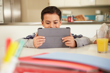 Boy Using Digital Tablet To Do Homework