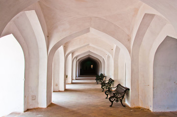 chair in Empty corridor with handcarved pillars in an abandoned
