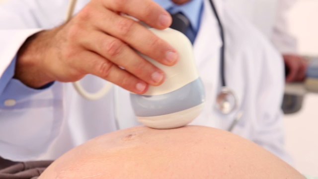 Pregnant woman having a sonagram scan