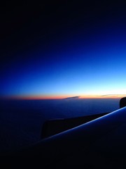 Fototapeta na wymiar blue sky morning sunrise through airplane window