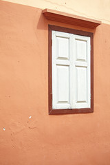 white window and orange wall in thailand