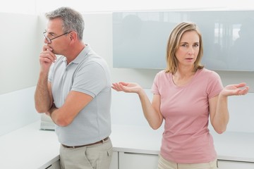 Fototapeta premium Unhappy couple having an argument in kitchen