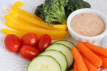 Obraz na płótnie Canvas Raw vegetables on white plate with dip