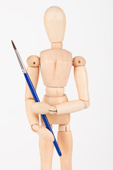 Plain wood mannequin stand upright isolated on white holding pai
