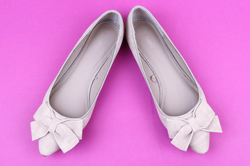 Beautiful grey female shoes, on purple background