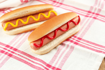 Tasty hot dogs on wooden table