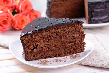 Delicious chocolate cake on plate on table close-up