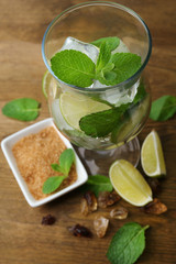 Ingredients for lemonade in glass, on wooden table