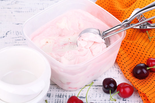 Ice cream in container and ice cream spoon