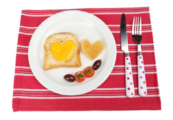 Scrambled eggs with bread on plate, on color napkin